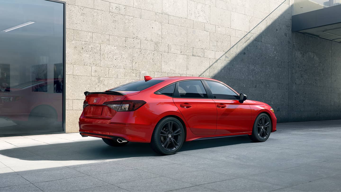 red 2026 honda civic si parked near building
