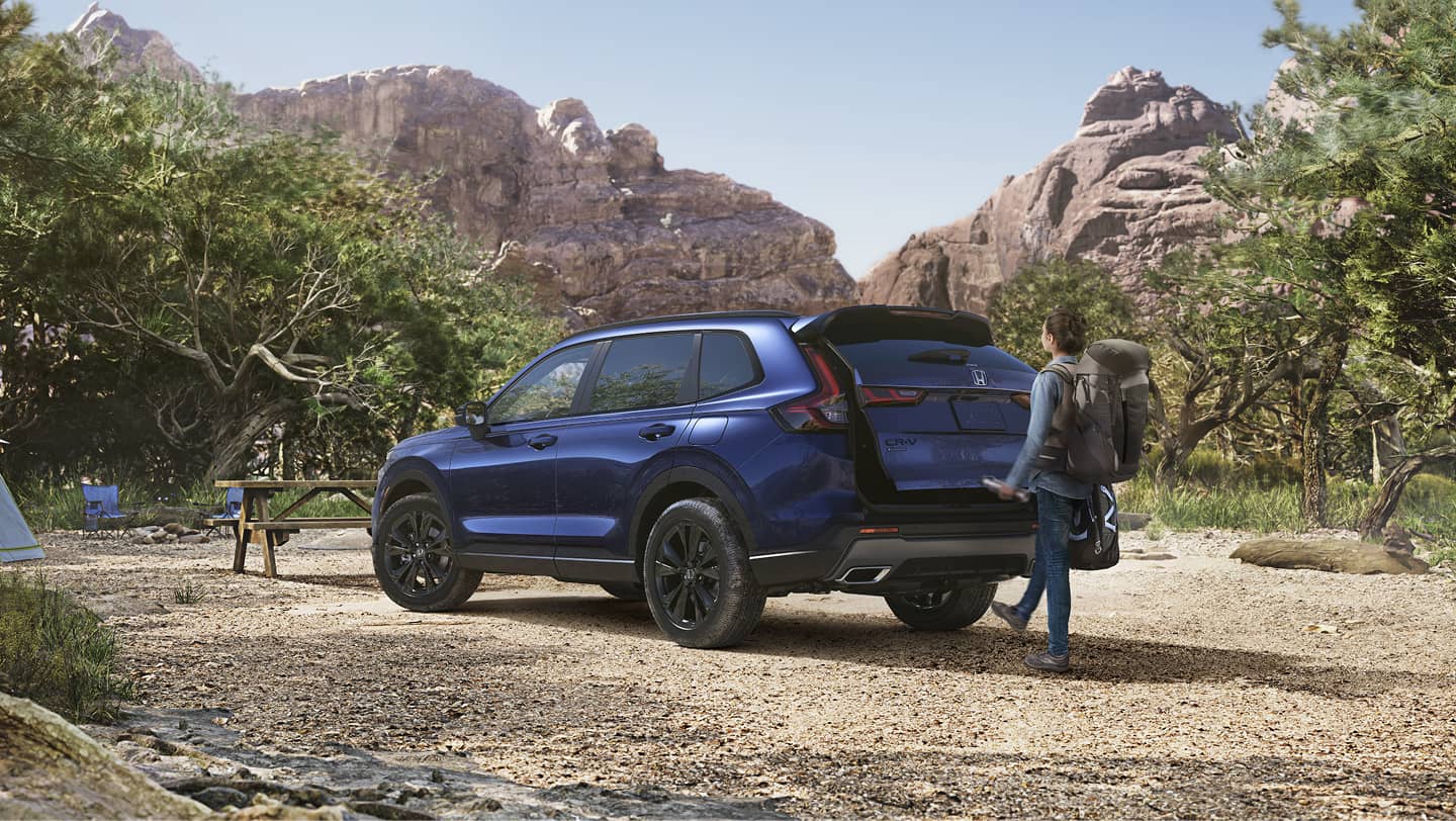 family next to honda cr-v in woods