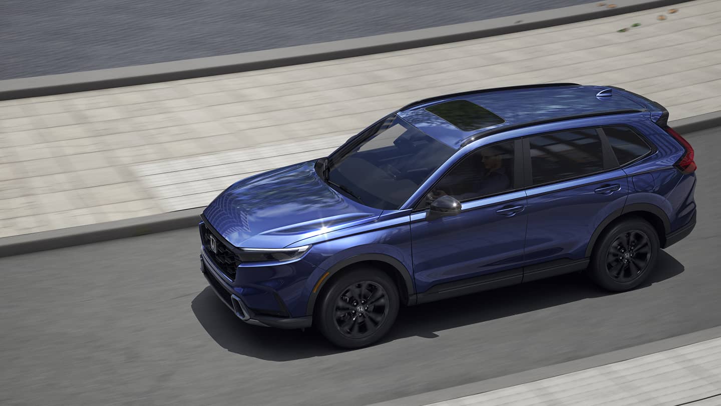 blue 2026 honda cr-v driving on street