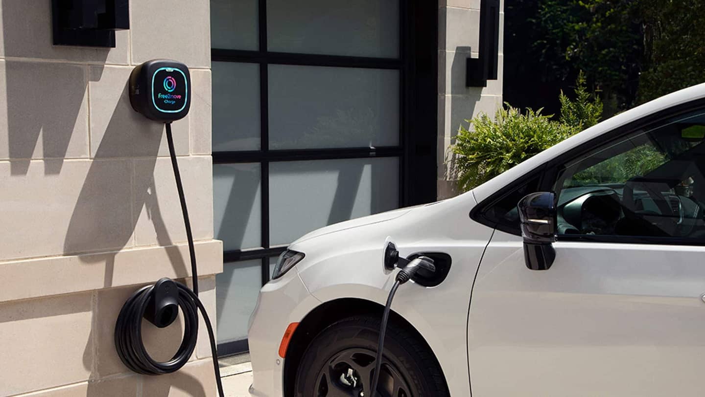 white chrysler phev charging in driveway