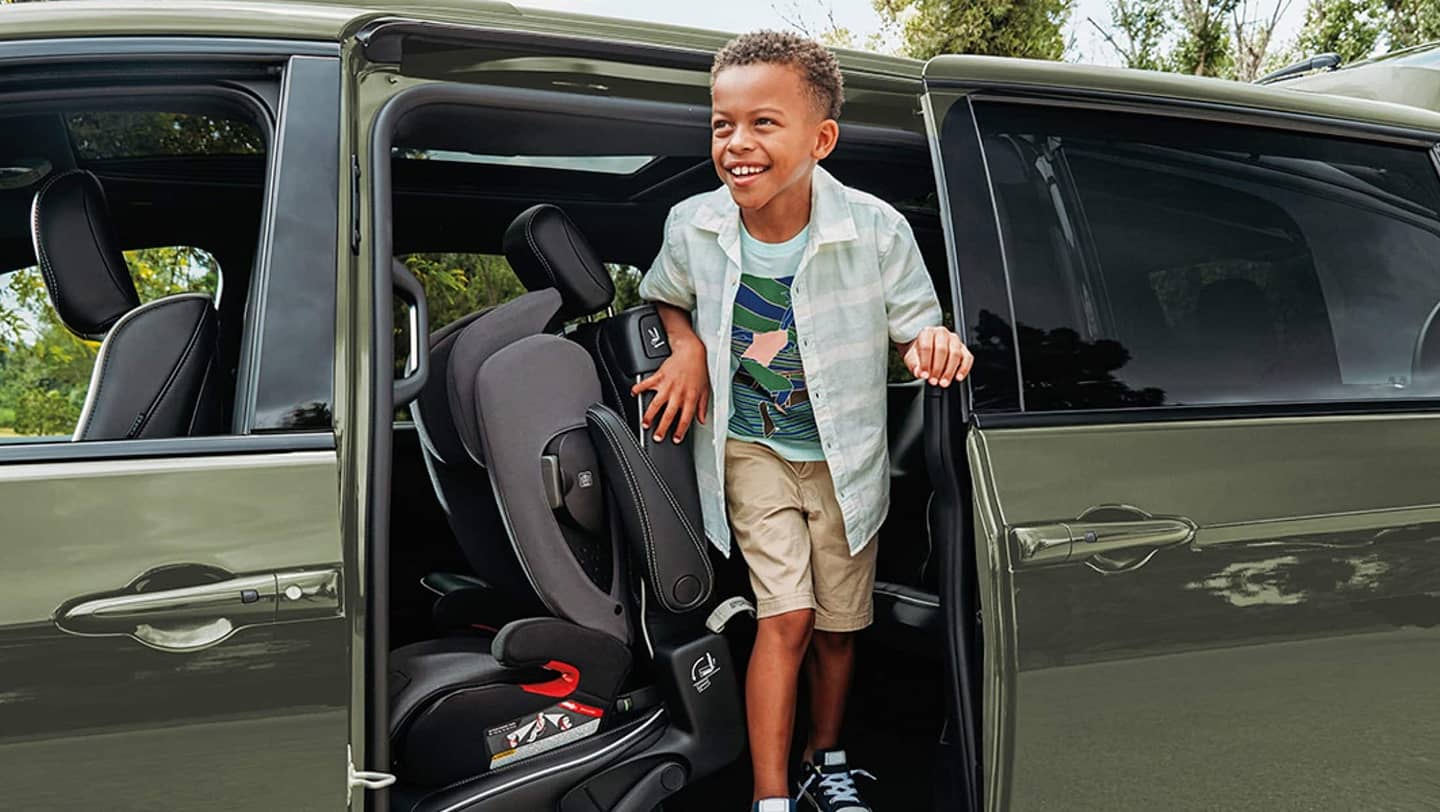 child coming out of door of 2026 chrysler pacifica phev door