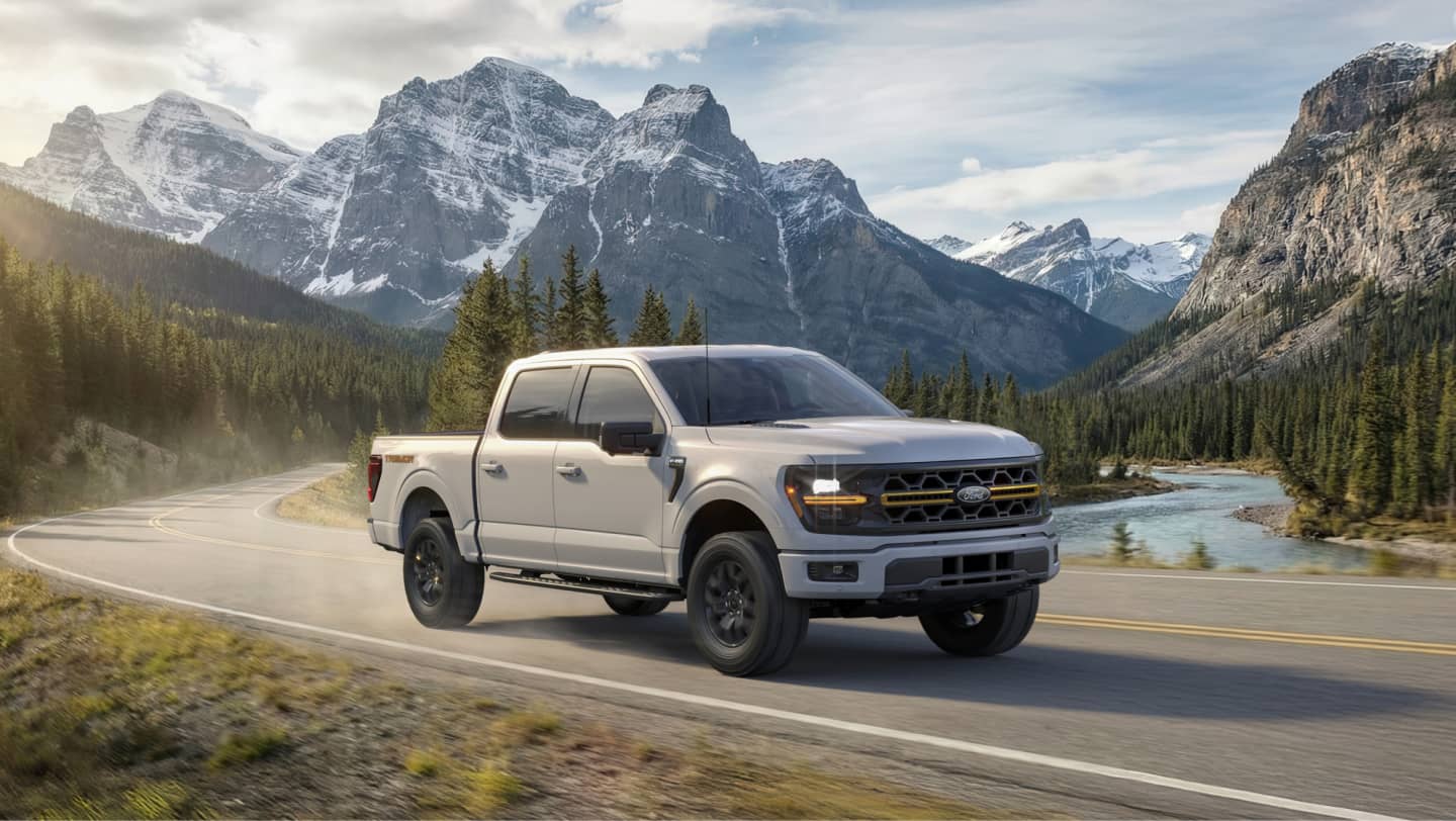 ford f-150 driving in front of mountains