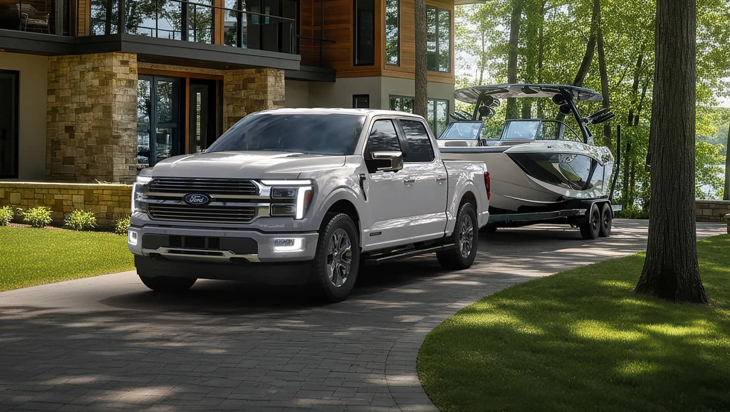 ford f-150 parked in front of home with boat trailing behind