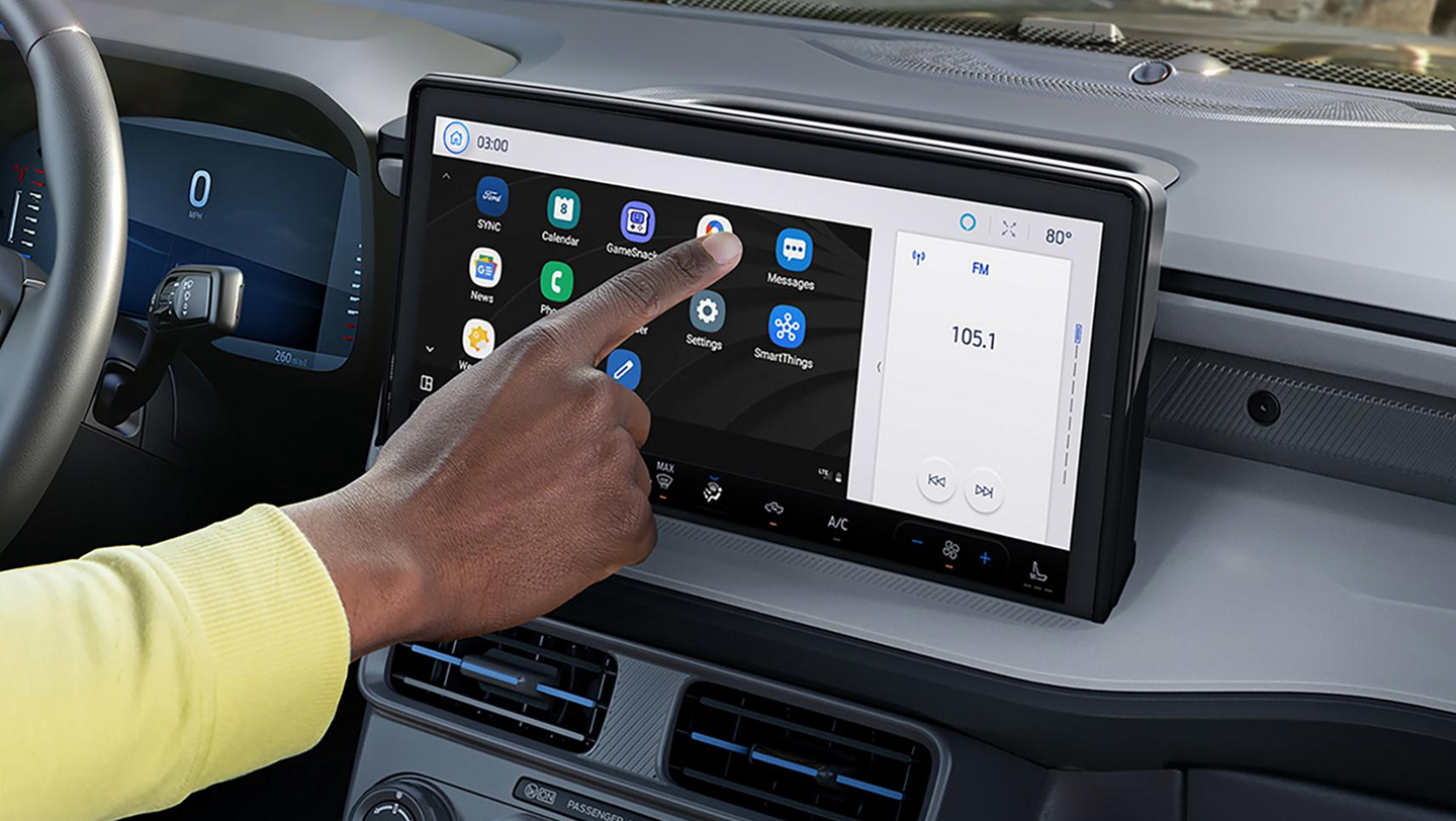 man touching dashboard screen of 2026 ford maverick