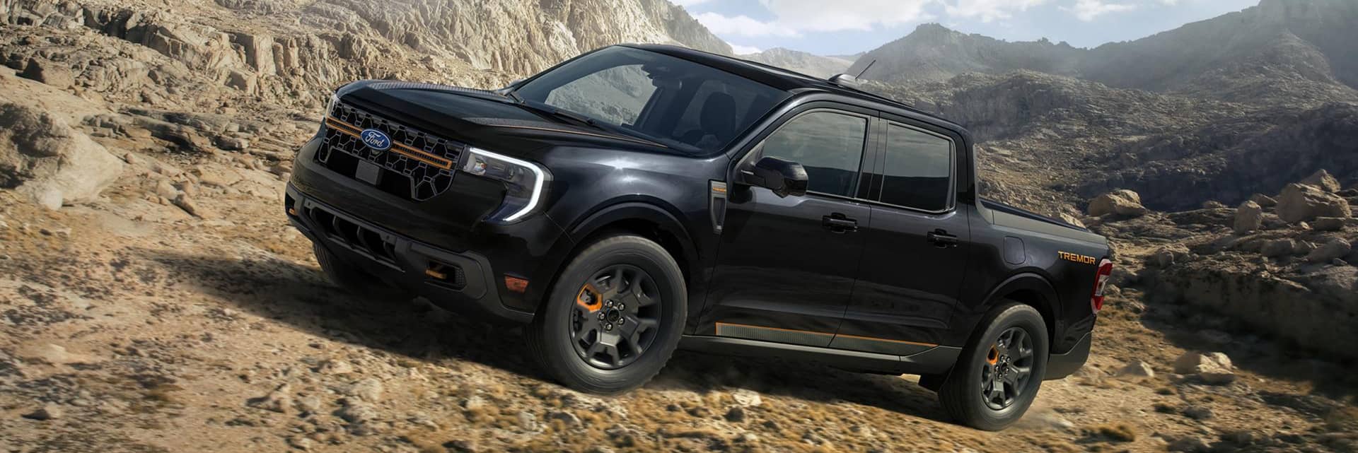 ford maverick parked on rocks by mountain