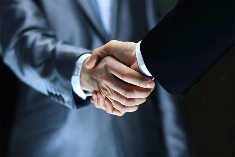 Businessmen in Suits Shaking Hands