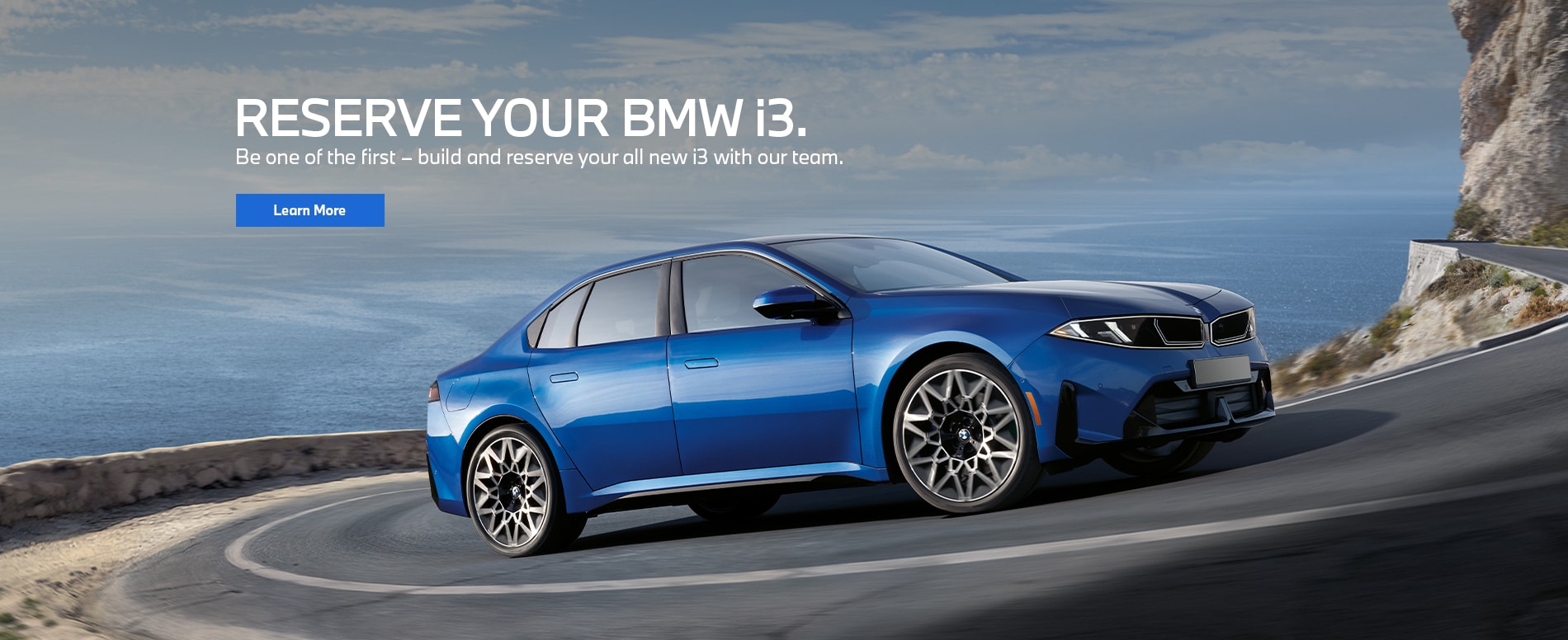 BMW i3 vehicle driving on a curved road.